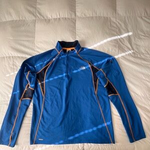 The North Face Men's Blue pullover with orange stitching.